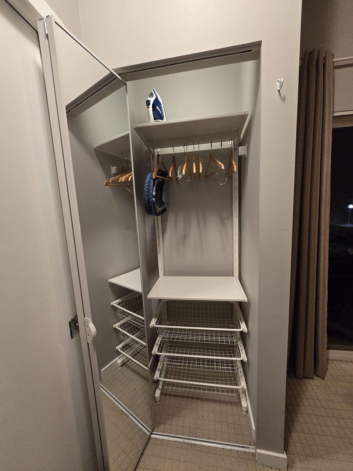 Second bedroom closet with hanging space, iron, and additional storage