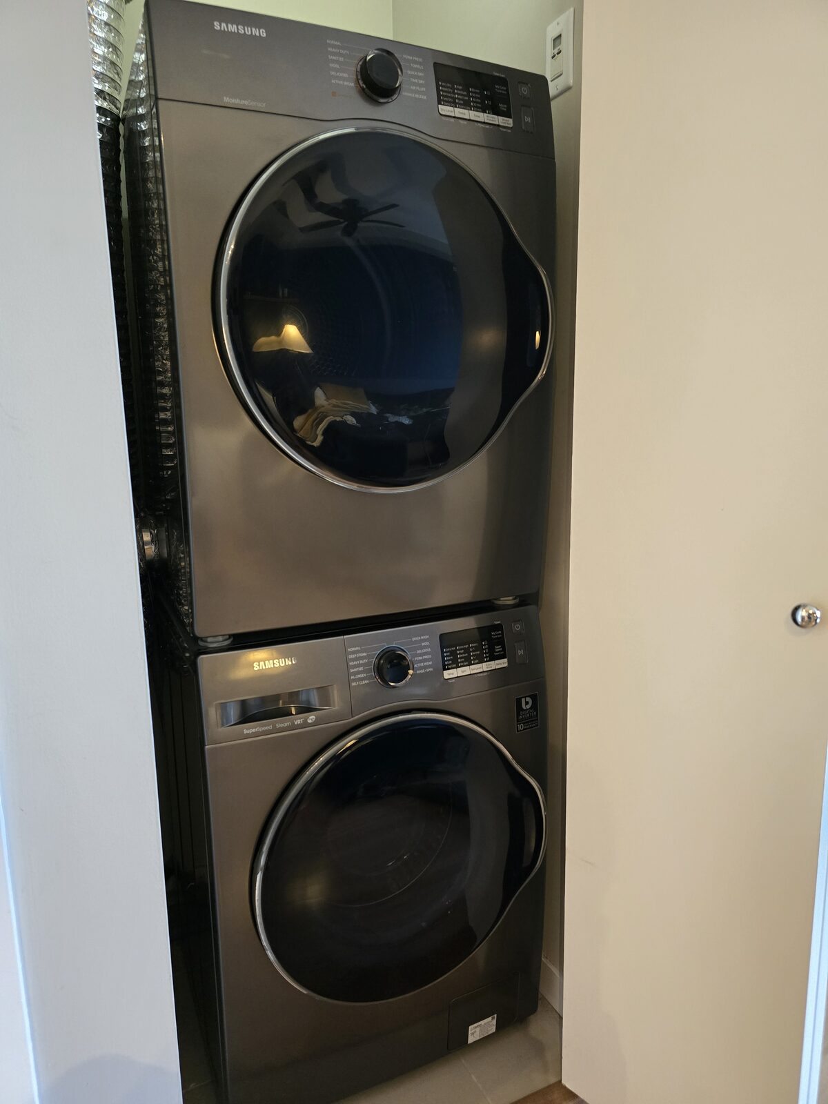 Close-up of the stacked Samsung washer and dryer with SuperSpeed Steam VRT controls