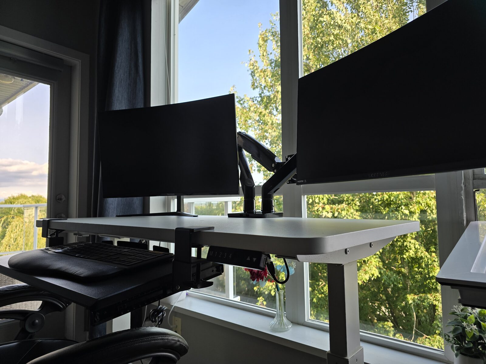 Angled view of the standing desk showing the electric height adjustment control
